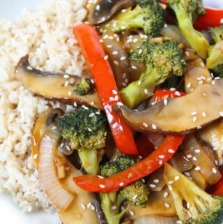 Vegan mushroom stir fry on a plate with brown rice