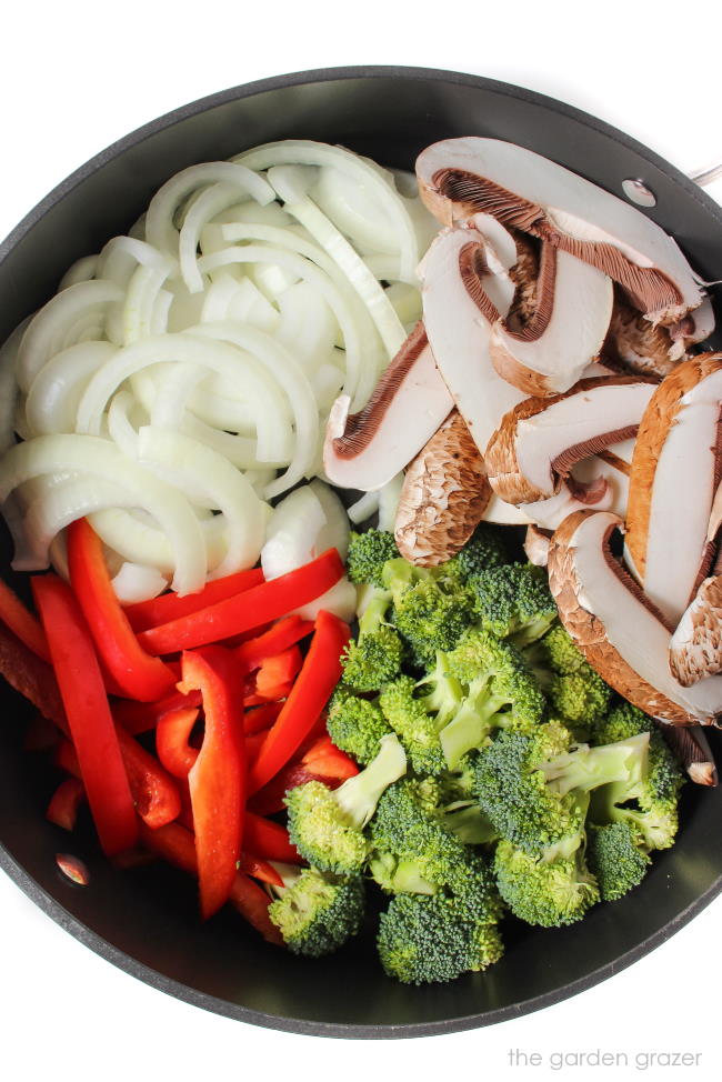 Ingredients for stir fry in a large skillet ready to sauté