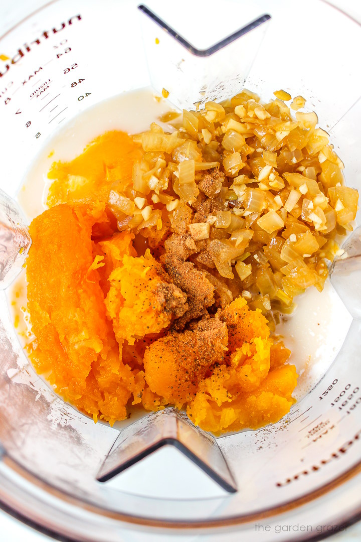 Overhead view of preparing soup ingredients in a blender before blending