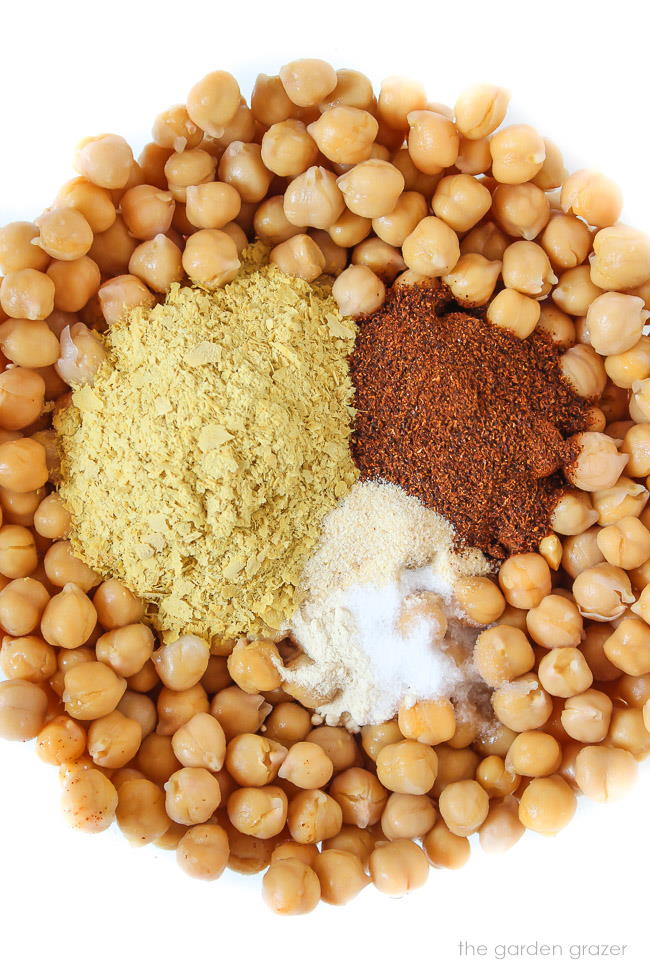 Ingredients in a bowl for cheesy nacho chickpeas