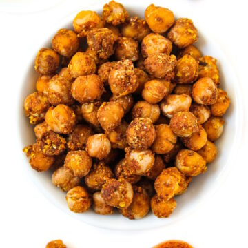 Overhead view of cheesy nacho roasted chickpeas in a small white bowl