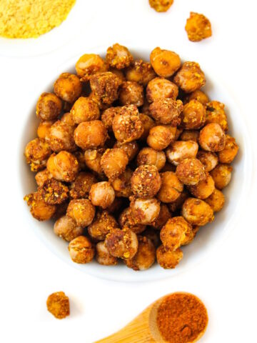 Overhead view of cheesy nacho roasted chickpeas in a small white bowl