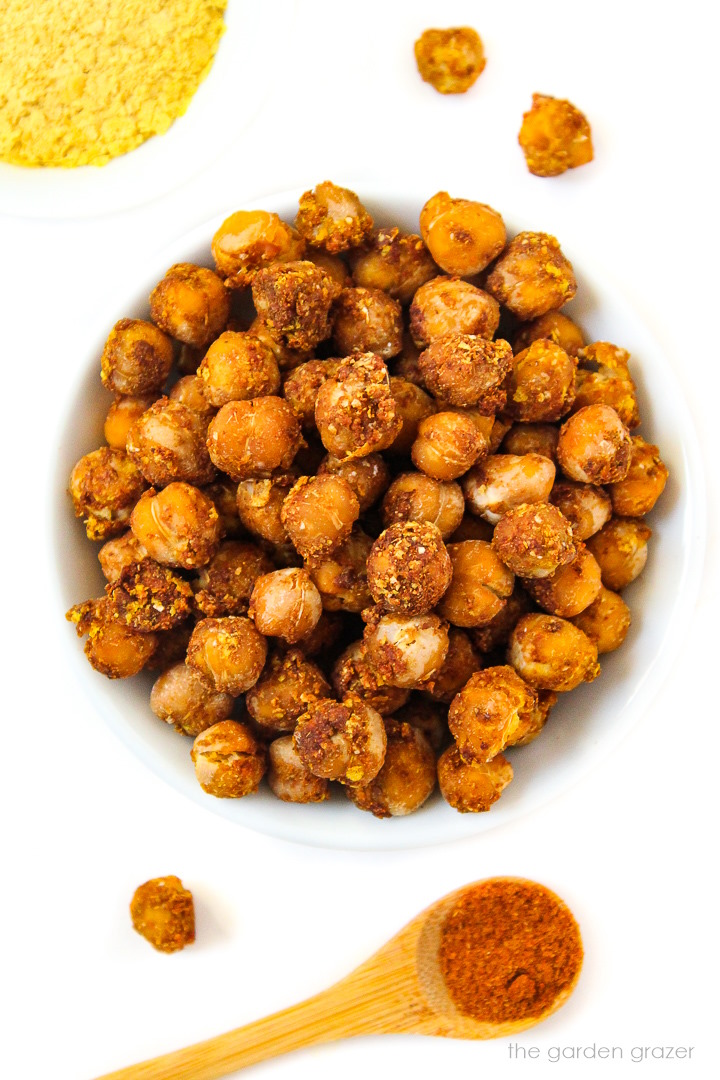 Overhead view of cheesy nacho roasted chickpeas in a small white bowl