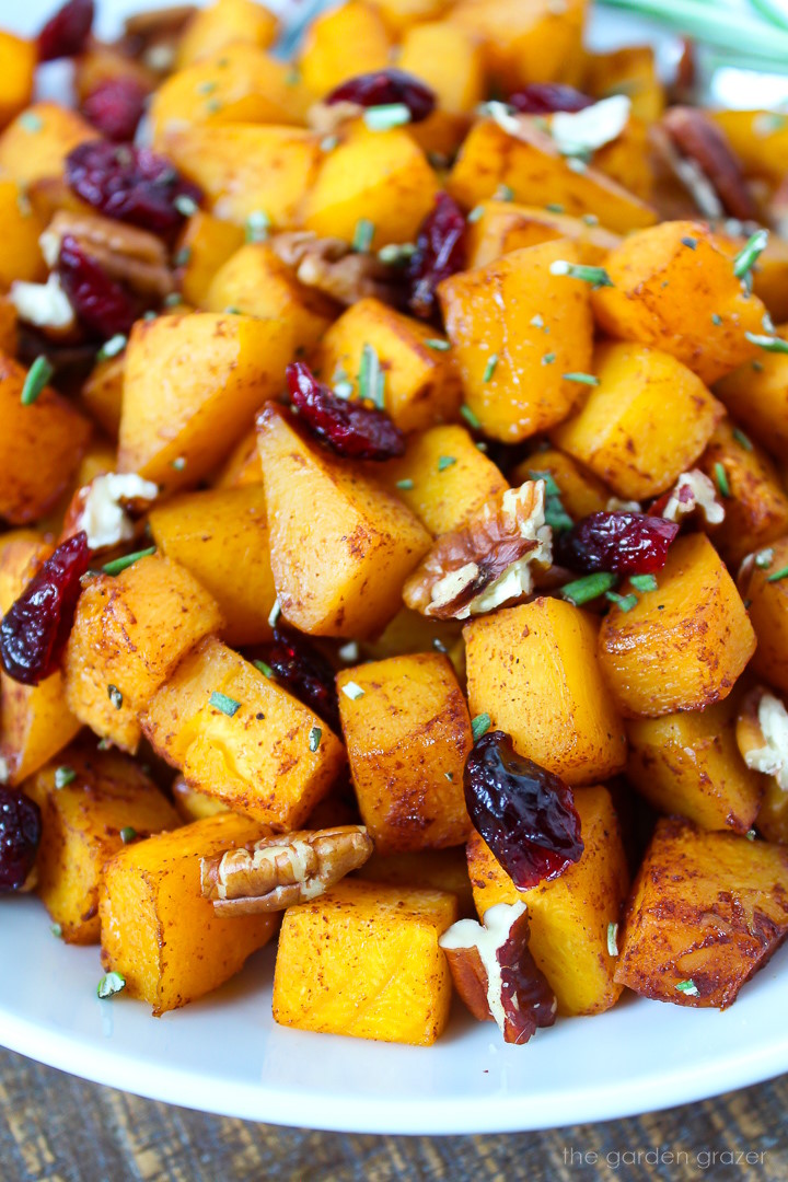 Close up view of maple cinnamon butternut squash served on a white plate