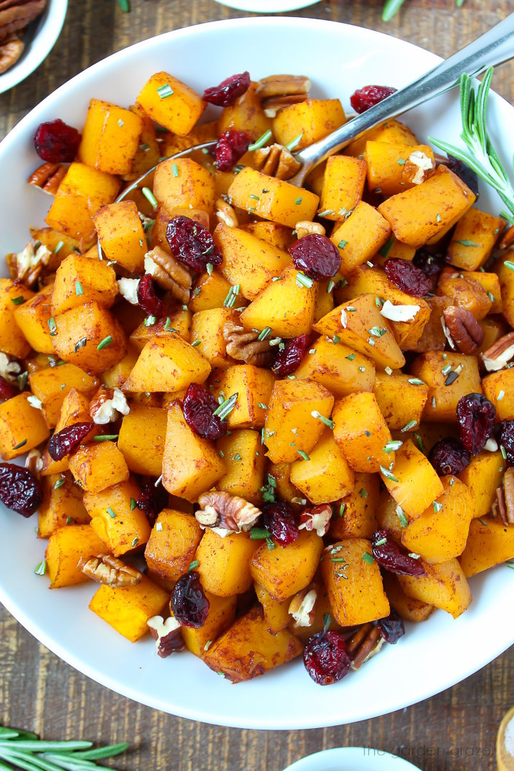 Overhead view of roasted maple cinnamon butternut squash on a wooden table
