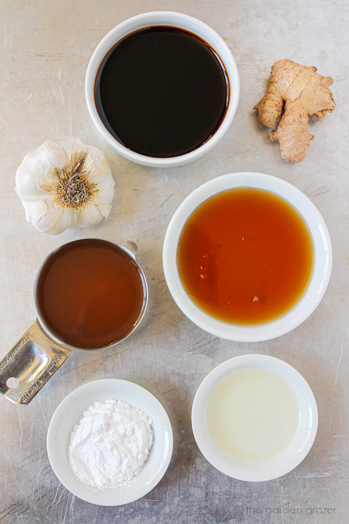 Tamari, rice vinegar, cornstarch, ginger, and garlic ingredients laid out on a metal tray