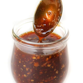 Glass jar with homemade teriyaki sauce and spoon