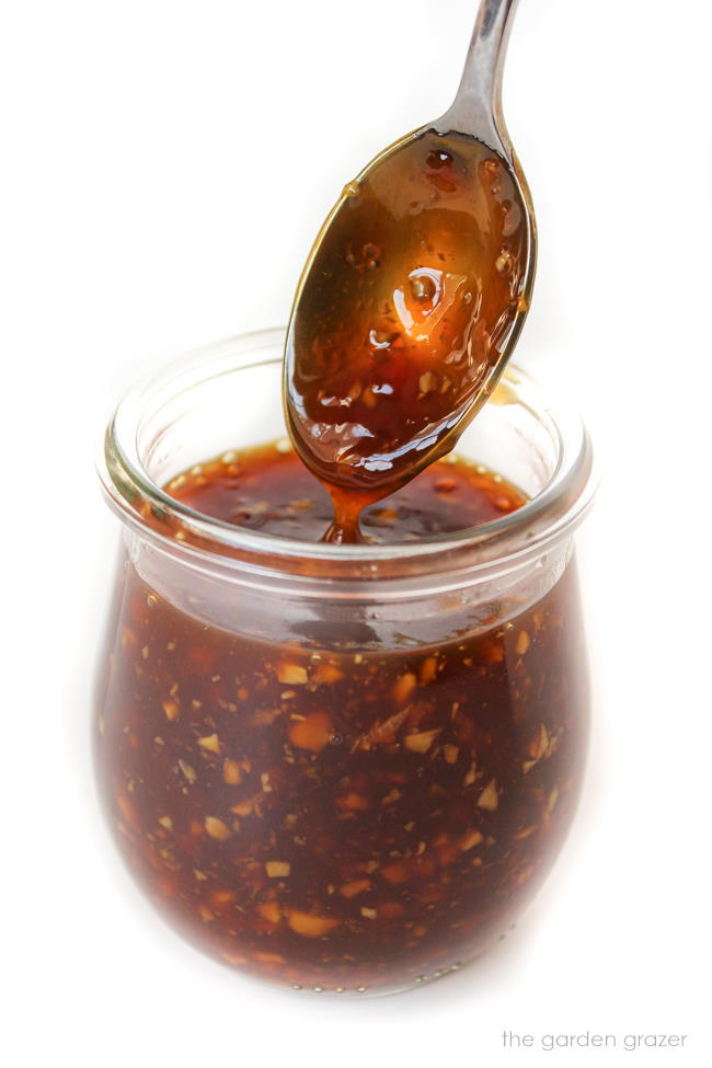 Glass jar with homemade teriyaki sauce and spoon