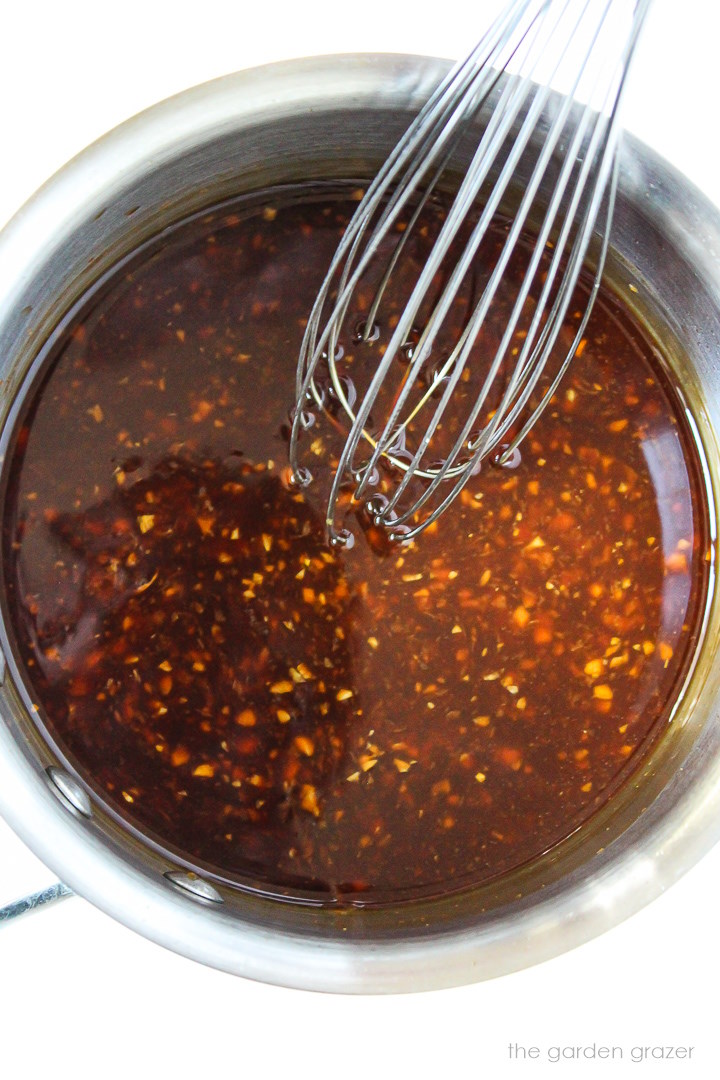 Cooking and whisking together teriyaki sauce in a small saucepan