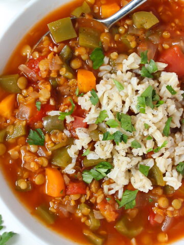 Lentil stuffed bell pepper soup in a white bowl