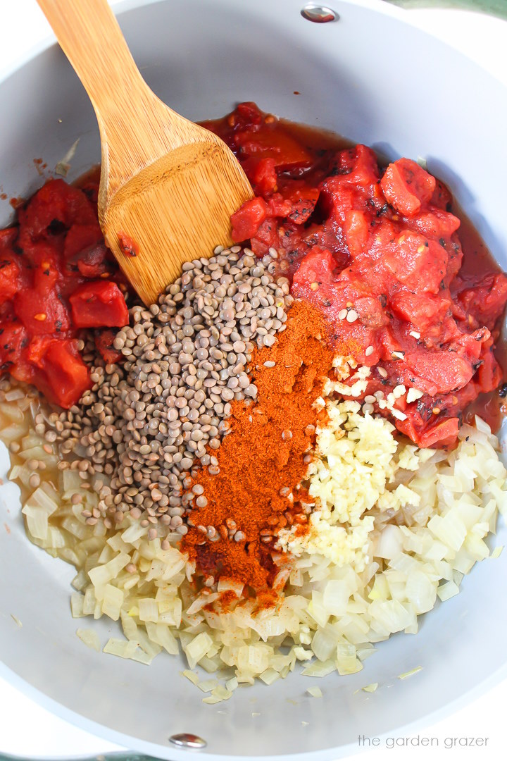 Overhead view of preparing soup ingredients in a large pot before cooking