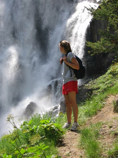 Kaitlin on a hiking trail in Yellowstone near a waterfall