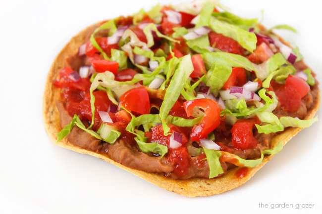 Bean tostada with salsa, lettuce, and tomato