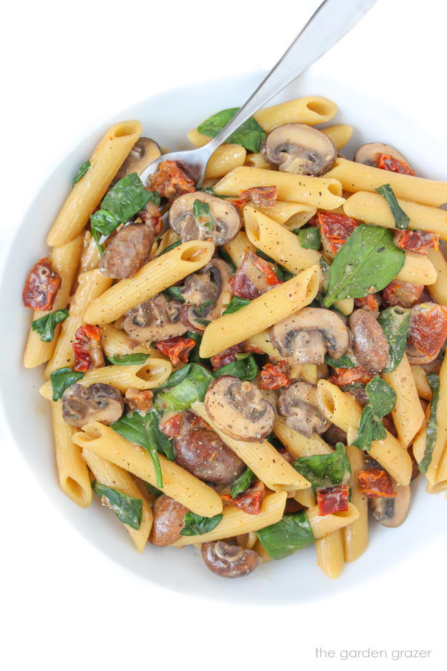 Bowl of spinach pasta with fork