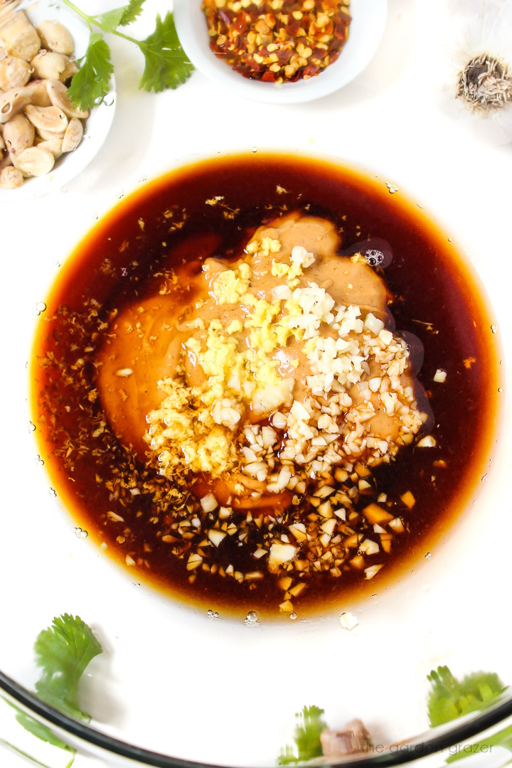 Overhead view of sauce ingredients in a glass bowl before mixing together