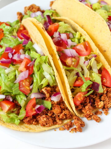 Tacos with chickpea walnut taco meat on a white plate