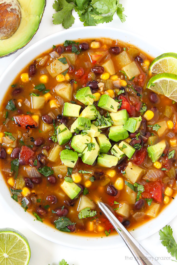 Close up view of vegan southwest soup with black beans in a white bowl