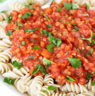 Bowl of pasta with vegan lentil bolognese sauce on top