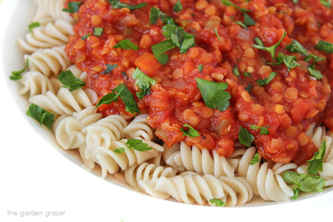 Bolognese sauce over fusilli pasta in a white bowl