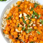 Vegan butter chickpeas served over rice and garnished with fresh cilantro and cashews