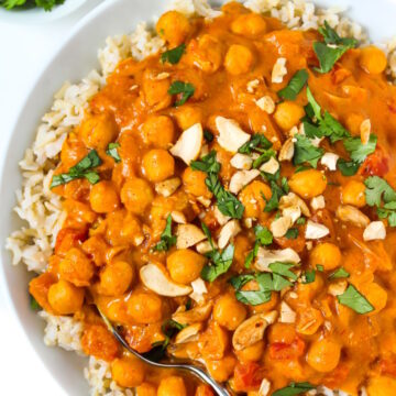 Vegan butter chickpeas served over rice and garnished with fresh cilantro and cashews