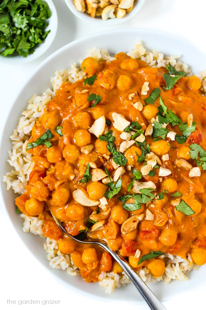 Vegan butter chickpeas served over rice and garnished with fresh cilantro and cashews