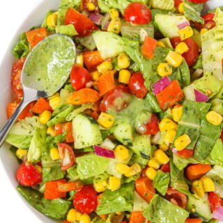 Plate of summer chopped salad tossed in creamy herb dressing