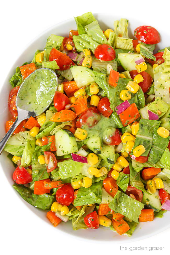 Plate of summer chopped salad tossed in green dressing
