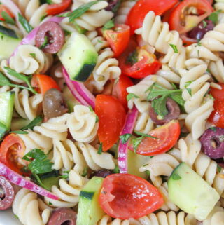 Vegan Pasta Salad in a bowl with tomatoes and cucumber