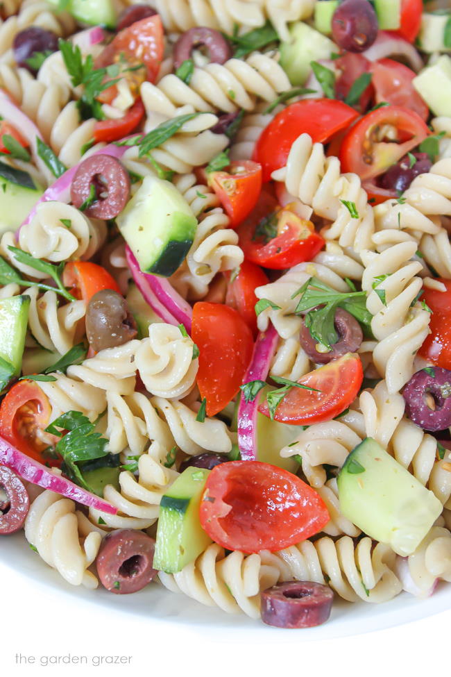 Vegan Pasta Salad in a bowl with tomatoes and cucumber