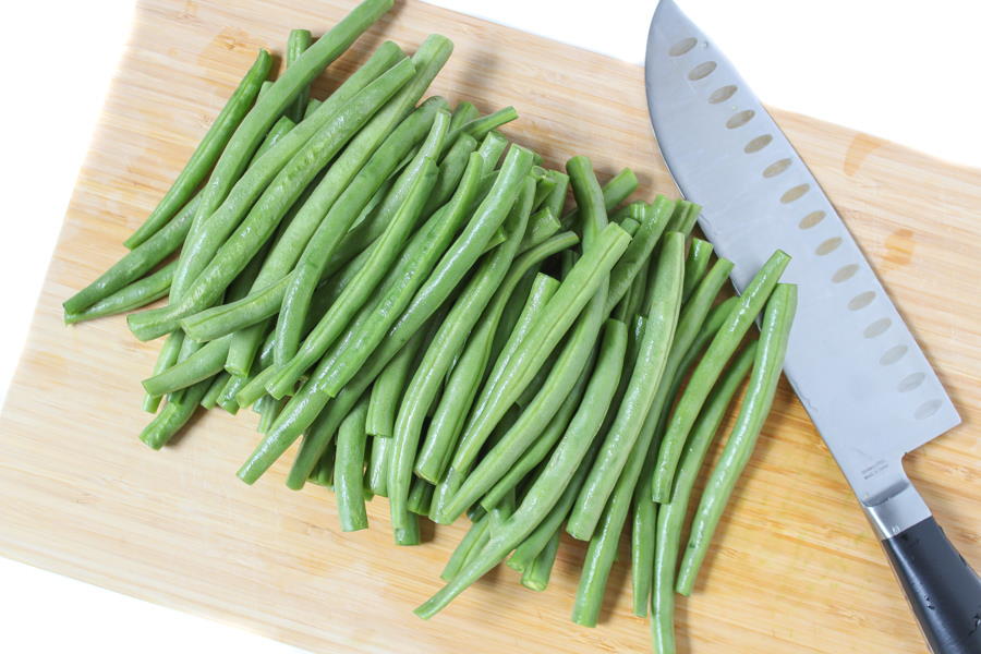 Fresh trimmed green beans on a cutting board