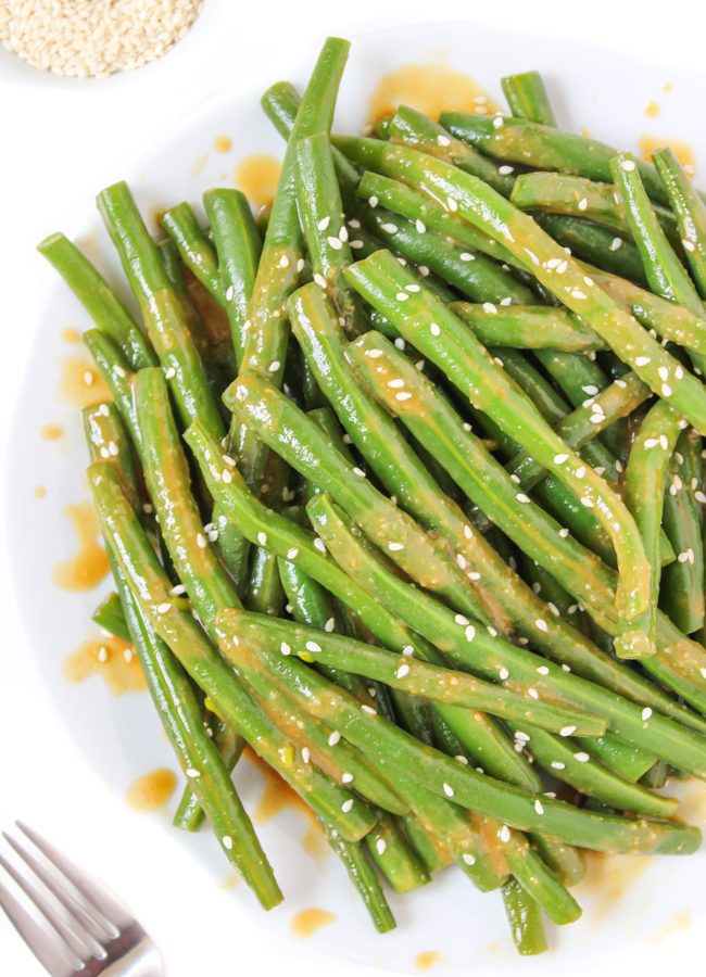 Plate of miso-glazed green beans with sesame seeds
