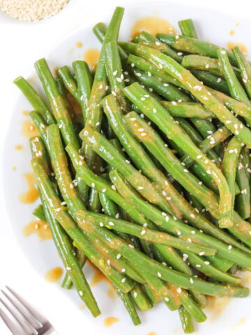 Plate of miso-glazed green beans with sesame seeds