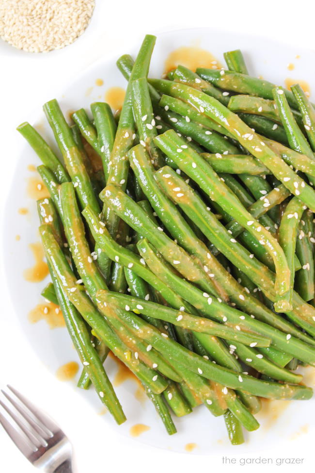 Plate of miso-glazed green beans with sesame seeds