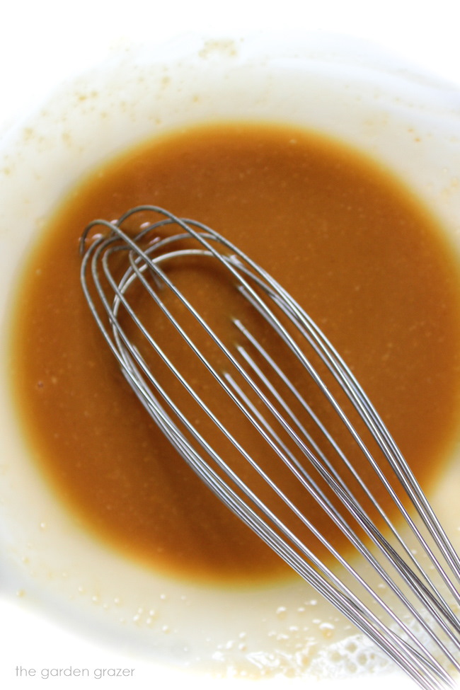 Whisking together the miso glaze in a glass bowl with metal whisk