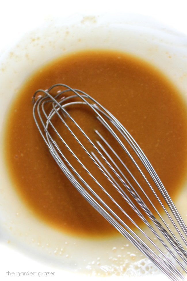 Whisking together the miso glaze in a glass bowl with metal whisk