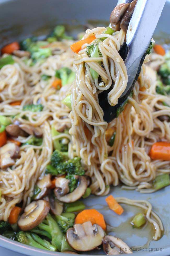 Pan of vegan noodles with teriyaki sauce and vegetables