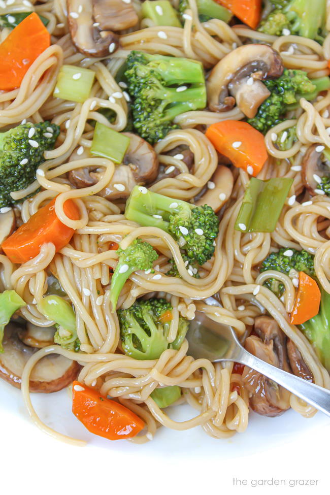 Teriyaki ramen on a white plate topped with sesame seeds