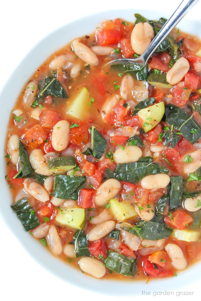 Bowl of vegan cannellini soup with kale