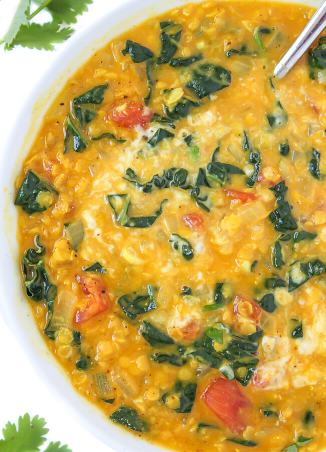 Vegan coconut curry lentil soup in a bowl with spoon