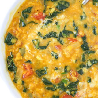 Vegan coconut curry lentil soup in a bowl with spoon