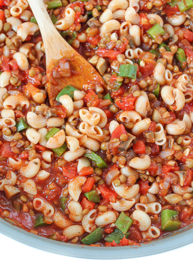 Skillet of vegan American goulash with lentils and mushrooms