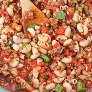 Skillet of vegan American goulash with lentils and mushrooms