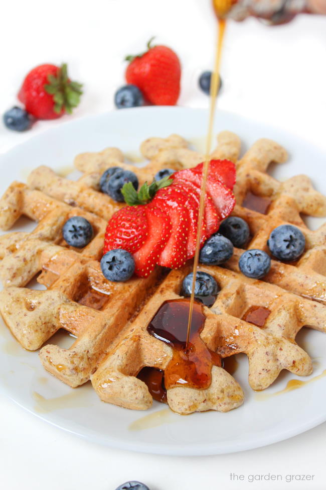 Plate of vegan gluten-free waffles with maple syrup