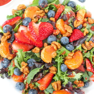Berry crunch salad on a plate with strawberry dressing