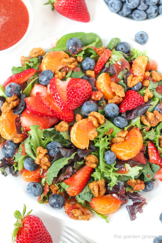 Berry crunch salad on a plate with strawberry dressing