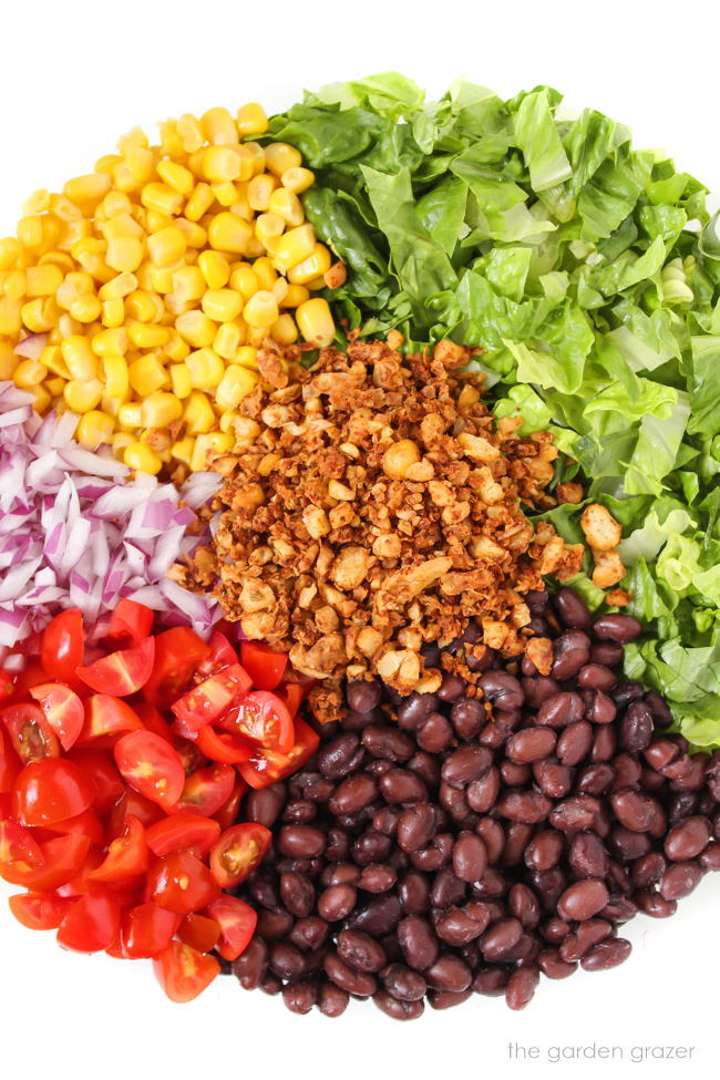 Ingredients in a white bowl for vegan taco salad