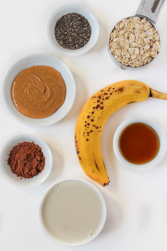 Ingredients spread out on a white table for overnight oats