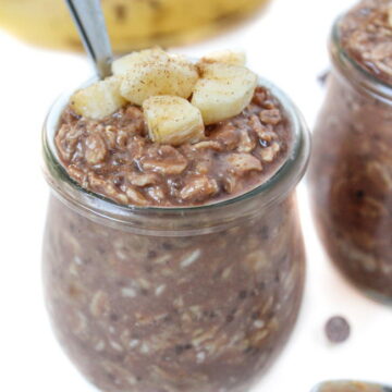 Small glass jar of chunky monkey overnight oats with spoon