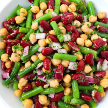 Overhead view of three bean salad tossed in a vinegar dressing with no refined sugar and no oil